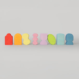 Grimm's Set of colorful, abstract wooden blocks on a light gray background