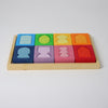 Grimm's Colorful wooden block set in a wooden tray on a light gray background