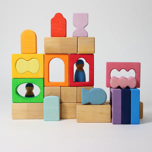 Grimm's Colorful wooden blocks with various shapes on a light gray background