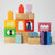 Grimm's Colorful wooden blocks with various shapes on a light gray background
