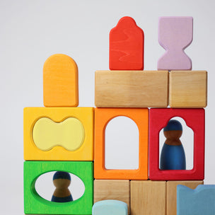 Grimm's Colorful wooden blocks with embedded figures on a light gray background