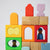 Grimm's Colorful wooden blocks with embedded figures on a light gray background