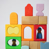 Grimm's Colorful wooden blocks with embedded figures on a light gray background