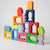 Colorful wooden blocks with various shapes stacked on a light gray background