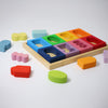 Colorful wooden shape sorter toy with various colored blocks on a white background