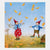 Two children in red hats and outfits standing in a field with falling leaves.