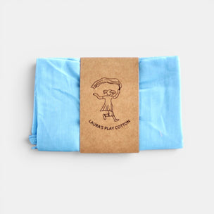 Laura's Play Cotton Folded blue fabric with a brown label on a white background