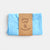 Laura's Play Cotton Folded blue fabric with a brown label on a white background