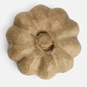 A single flower-shaped textured object made of natural brown paper or cardboard, photographed from above on a plain white background.