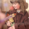 Child holding a doll with a blurred background