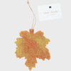 Decorative leaf-shaped item with a 'Ohh! Lovely!' tag on a white background