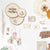 Collection of nature-themed decorative items including wooden slices, tags, and a embroidery hoop with flowers on a white background.