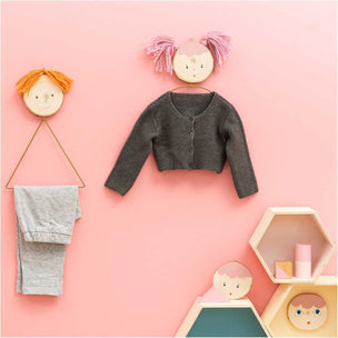 Children's clothing and accessories on a pink background