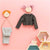 Children's clothing and accessories on a pink background