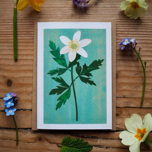Floral illustration on a wooden surface with real flowers.