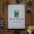 Card with wood anemone illustration and text on a wooden surface with flowers