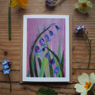 Artistic depiction of flowers on a wooden surface with real flowers around
