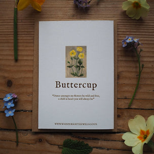 Buttercup card with flowers on a wooden surface