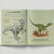 Open book with illustrations of a dinosaur and its skeleton on a light gray background