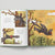 Open book with illustrations of a bird in a forest setting