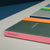 Colorful notebooks with 'PROJECTS' on a gray surface