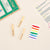 Wooden clothespins and a set of rainbow-colored clothespins on a beige surface with instructions.