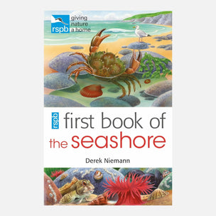 Front cover of the children's book 'first book of the seashore' by Derek Niemann, published by RSPB Giving Nature a Home. The cover features colorful illustrations of a crab on a sandy beach, rocks and water, and sea life at the bottom, set against a white background.