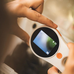 Digital MICROSCOPE being held by a person with a blurred background