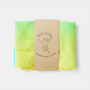 Folded green and yellow fabric with a brown card labeled 'Laura's Play Cotton' on a white background