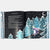 Open book with a winter scene illustration and text on a white background
