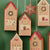 Set of Christmas-themed house-shaped boxes on a green background