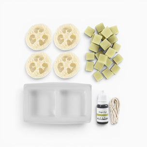 Set of sponges, soap bars, a bottle, and a rope on a white background