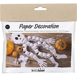 Package of paper decoration kit with skeleton design on a wooden surface