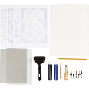 Collection of printmaking tools including a roller, stamps, and ink bottles on a white background.