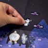 Hand interacting with ghost stickers on a dark background