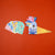 Colorful bird-shaped product with 'Be Wild!' text on an orange background
