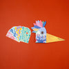 Colorful bird-shaped product with 'Be Wild!' text on an orange background