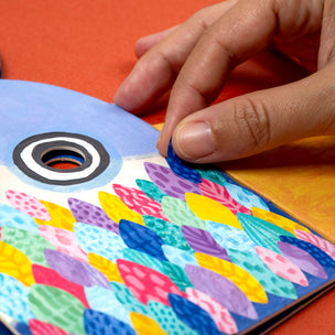Colorful children's book with a hand turning a page