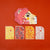 Londji Colorful animal-shaped stickers on a red background with 'BE WILD!' text.
