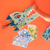 Colorful paper craft of a crocodile on an orange background