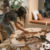 Grapat Avent Calendar 2025 Woman baking cookies at a wooden table in a cozy kitchen.