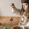 Grapat Avent Calendar 2025 Child playing with small toys on a wooden floor