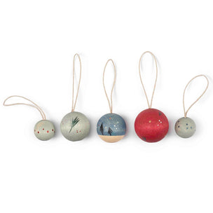 Set of five small round decorative items with strings on a white background