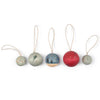 Set of five small round decorative items with strings on a white background