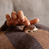 hand holding a small wooden hedgehog 