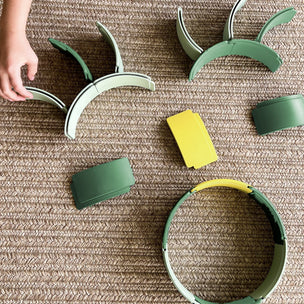 Green and yellow children's playset on a textured surface