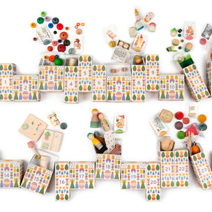 A grapat advent set arranged on a white background, featuring patterned game blocks, loose colorful game pieces, and small illustrated cards.
