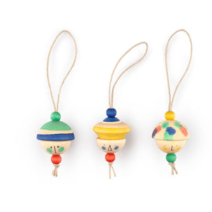 Three colorful wooden hanging ornaments with looped strings, decorated with painted stripes and dots in green, blue, yellow, red, and white, shown on a plain white background.