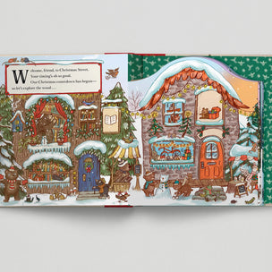 Magic Cat Illustrated Christmas scene with houses and snow, featuring a snowy village setting.