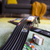 Toy car track set on a carpeted floor with a blurred living room background